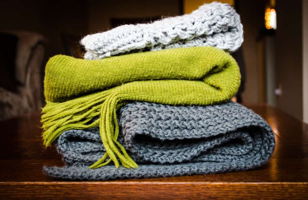 Winter scarfs stacked on a shelf