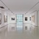 An art gallery with white walls and paintings on the walls